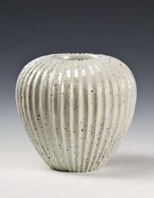  A stylized white vase with vertical ribbing and speckling on a dark gray gradient background. Artist name and title are unknown.