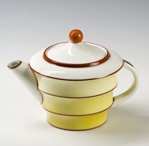  "Modell 1867" a feldspar porcelain teapot designed by Porsgrunds Porselænsfabrik AS, featuring a pastel yellow body with a white upper section, russet brown accents on the lid's edge and rim, and a brown spherical finial on the lid. The teapot is set against a light, neutral background.