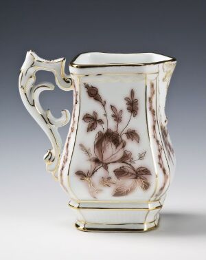  Porcelain jug by Porsgrunds Porselænsfabrik AS with a creamy-white base, adorned with brown floral underglaze decorations, and gilded accents along the rim, handle, and base. The jug has an ornate handle and a curved, elegant body.