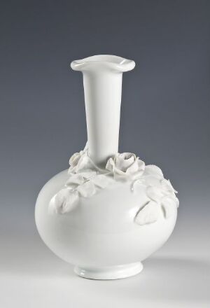  A white porcelain vase with three-dimensional flower decorations on a bulbous body and a slender neck, displayed against a soft gray gradient background.