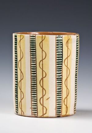  A decorative cylindrical object with a cream/beige base color and a pattern of vertical black lines and wavy lines alternating with stripes of teal and black.