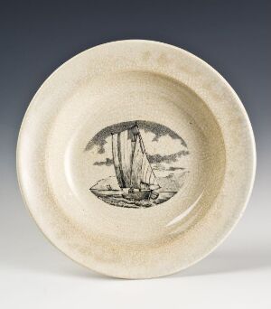  A cream-colored ceramic plate featuring a central sepia-toned illustration of a classic sailing ship with two masts and billowed sails, set against a lightly textured background indicative of the sea.