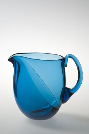  A beautifully designed deep blue, blown glass pitcher by Ingeborg Lundin, titled "mod. 460", featuring an elegant handle and a twisted pattern on its surface, set against a white-to-grey gradient background.