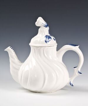  An elegant white porcelain teapot with a squash-like textured body, featuring blue accents on the handle and the lid's top, set against a neutral gray background.