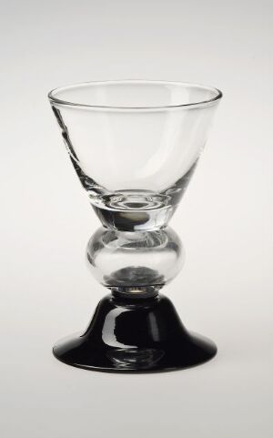  A blown glass cup or goblet with a transparent upper and bulb center, and a dark tinted base, designed by Sverre Pettersen, titled "nr. 9023," against a plain white background.