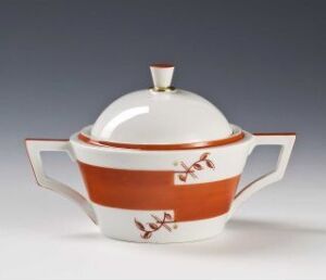  A Feldspar porcelain soup tureen with a white base, designed by Nora Gulbrandsen, featuring a broad orange band and stubby, hand-painted, brownish-red botanical patterns around it, with wide flared handles and a rounded lid with a simple finial on top against a light background.