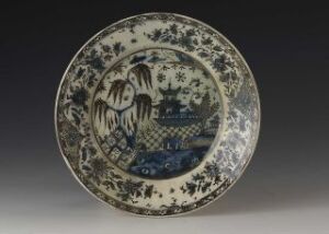  An antique Chinese blue and white porcelain plate with intricate landscape and floral designs. Artistname and title remain unknown.