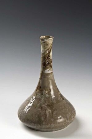  An antique-looking, flask-shaped glass vase with a mottled brown pattern, displayed against a gradient gray background.