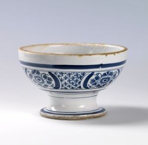  A historical style white porcelain bowl with intricate blue patterns and a footed base, adorned with a thin golden border along the rim and interior lip, suggesting traditional East Asian ceramic design.