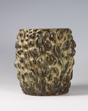  A textured cylindrical ceramic vase with a pattern resembling clustered organic shapes in muted earth tones of dark green, brown, and yellow, set against a light gray background.