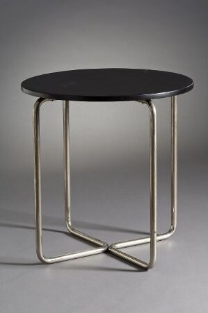  "Nr. 13," a modern circular table designed by Josef Kussius Metallvarefabrikk, with a dark-colored pine top and polished form-bent steel legs in an X-shaped base, exemplifying minimalist design and craftsmanship.