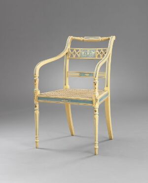  An exquisite beech wood chair with woven rattan seat and backrest, designed by Joseph Chr. Lillie, titled "Stol." The chair features ornately turned and carved legs, armrests, and a decorative backrest panel with subtle painted details.