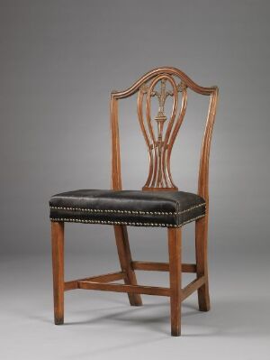  An elegant chair made of dark reddish-brown mahogany with a lyre-shaped backrest and a dark upholstered seat with nailhead trim, blending classic design with expert craftsmanship.