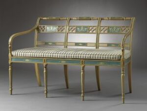  An ornate, historical bench with a golden frame and pale green striped upholstery set against a dark gray background. The bench exhibits neoclassical design elements with intricate back panel details and elegant leg decorations. Artist name and title are unknown.