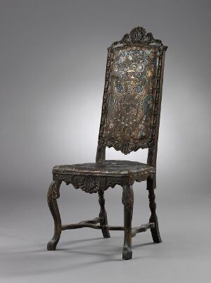  An antique baroque-style chair with a high back and intricate dark wood carvings, featuring an upholstered backrest and seat with a faded patterned design, set against a gradient background transitioning from light at the bottom to dark at the top.