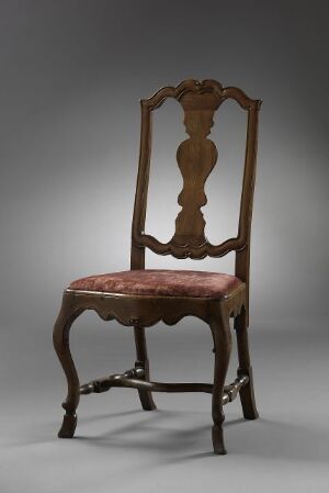  An antique wooden chair with red velvet upholstery, featuring intricate wood carving on its tall backrest and cabriole front legs with claw-and-ball feet, set against a gradated grey to black background. Artist name and title are unknown.