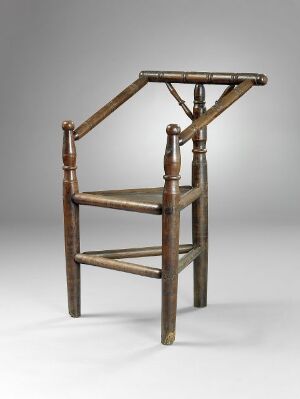  An antique wooden chair with the capability of transforming into steps, featuring turned spindles and a high backsplat, in a brown wood finish against a neutral background. Artist Name and Title are unknown.