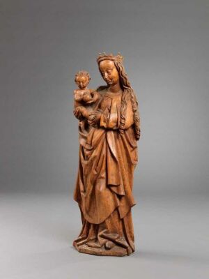  A carved linden wood statue portraying the Virgin Mary holding the infant Jesus, with intricate details in the drapery of their robes and serene expressions, set against a neutral gray background. Artist name and title of the work are unknown.
