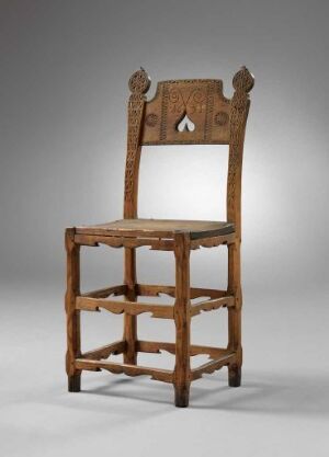  An antique wooden chair with a rich brown tone, featuring a shaped crest rail with a decorative cut-out at the top, straight wooden backrest, turned front legs, multiple stretchers for support, and no seat, set against a light grey to white gradient background.