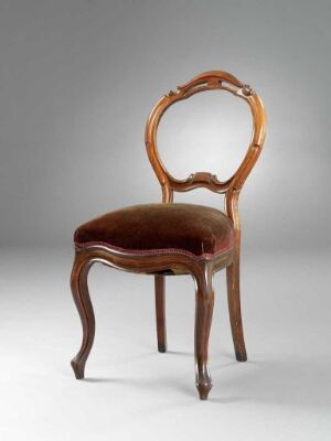  An antique wooden chair with elegant curved legs and an oval looping backrest, upholstered in a brown material to match the glossy wooden finish, set against a light grey backdrop. Artist name and title are unknown.