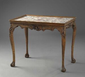  "Tebord," an antique birch wood table designed by J.C. Michelsen, featuring ornate legs and edges with a decorative painted faience tile inset in the tabletop.