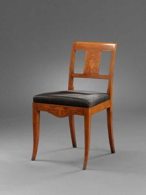  An antique wooden chair with a glossy golden-brown finish and black leather upholstered seat, set against a soft grey to white gradient background.