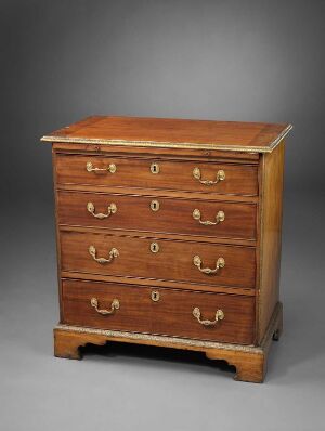  A traditional wooden chest of drawers with a warm honey-brown finish and brass half-moon handles on each of the four drawers, displayed against a neutral dark grey background.