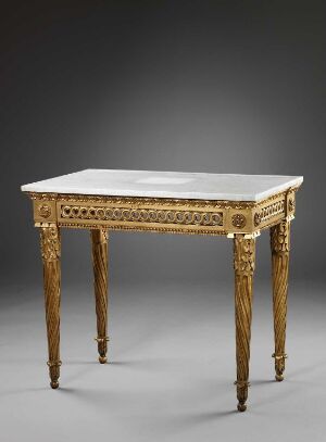  An antique rectangular table with white or light-gray marble top and ornately carved gold gilt legs and apron, set against a neutral gray background.