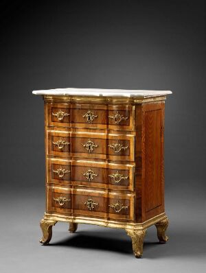  An antique serpentine-fronted chest of drawers, with a marbled white top and decorated with inlaid polished wood in warm brown tones, including ornate metal handles, set against a grey background. Artistname and title are unknown.