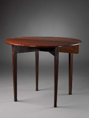  A vintage-style wooden table with a dark brown finish, featuring a rounded rectangular top, tapering legs, and a simple apron, against a soft gray gradient background.