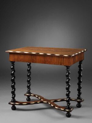  An antique table with a warm honey-brown rectangular top with scalloped corners and ornate, twisted black legs, connected by 'X' shaped crossbars, against a gray backdrop. Artistname and title are unknown.