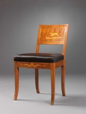  An elegant wooden chair with light caramel brown legs and frame, featuring a dark brown upholstered seat and a golden-hued intricate inlay design on the backrest, set against a gray background.