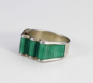  "Bølge" by J. Tostrup, a sterling silver bracelet with transparent green enamel detailing, capturing the essence of waves with its ridged, vibrant green inlays set against solid silver sections, showcased on a neutral background.