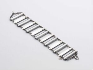  A polished silver bracelet with rectangular bar links and a discreet clasp, displayed on a light gray background.