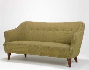  "Modelltegning 1417," a mid-century modern sofa by Rastad & Relling, with olive green wool upholstery and angled mahogany legs, highlighting the elegant curves and tufted backrest design.