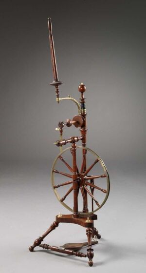  An antique wooden spinning wheel with a large wheel and multiple wooden rods on a soft gradient grey background.