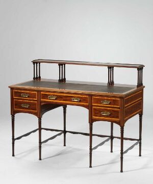  An antique mahogany writing desk with a raised gallery, brass handles on its drawers, and eight slender legs, set against a neutral background.