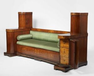  Vintage wooden bench-style sofa with rich brown frame and muted green cushions, exuding an early 20th-century aesthetic.