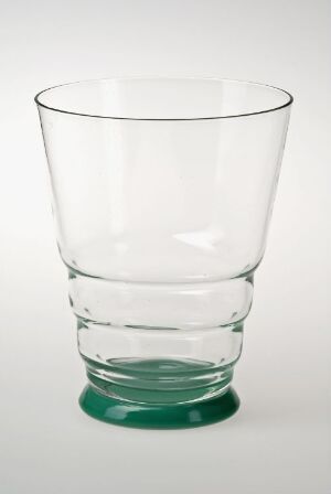  A clear glass tumbler with a green-tinted base sits against a white background, featuring a simple design that is wider at the top and narrows down slightly towards the base.