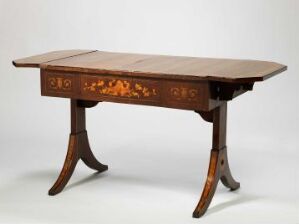  A traditional wooden drop-leaf table with a rich chestnut brown finish and inlaid decorative details, stabilized on curved legs with a horizontal stretcher, set against a light grey background.