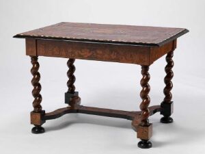  An antique dark brown wooden table with barley-twist legs and a rectangular top, elevated slightly by small spherical feet, displayed against a neutral background.