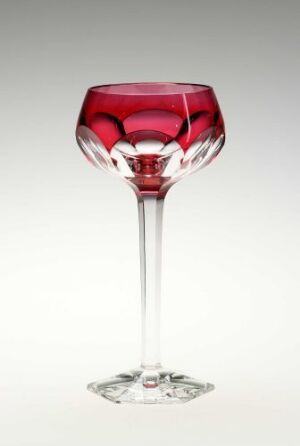  A unique wine glass with a vibrant ruby red bowl and a clear stem, highlighted against a soft gradating background from gray to white.