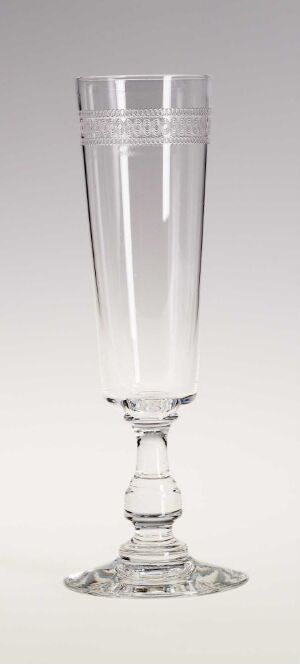  A tall, transparent glass with a thin stem and a circular base, standing against a gradient white-to-gray background.