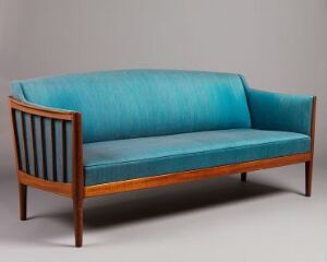  A mid-century modern style sofa with a wooden frame and vibrant teal blue upholstery, set against a neutral gray background.