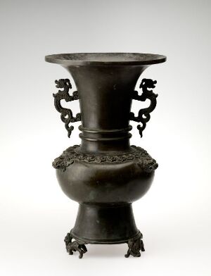  An ancient bronze vessel with a flared mouth, ornate high-relief band, and animal-shaped feet, evoking traditional Asian metallurgy.