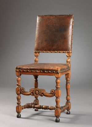  An antique wooden chair with turned legs and an H-shaped stretcher, upholstered in aged leather, against a neutral gray background. Artist and title are unknown.