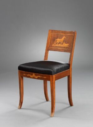  A classical wooden chair with a black upholstered seat and an intricate, lighter wood inlay design on the backrest, set against a gray background.