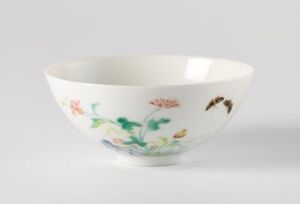  A porcelain bowl with a glossy finish, featuring delicate botanical and insect illustrations in pastel colors on a white background, evoking a sense of traditional East Asian ceramic craftsmanship.