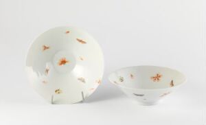  Two porcelain pieces, a plate, and a bowl, with painted goldfish and green plant motifs on a creamy white background, artist name, and title unknown.