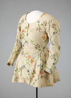  Vintage floral dress with a creamy beige base, adorned with detailed pastel-colored floral patterns, displayed on a mannequin against a light gray background. Artist name and title: Unknown.